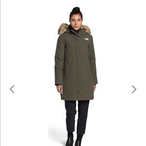 Taupe green north face puffer jacket with furry hood.